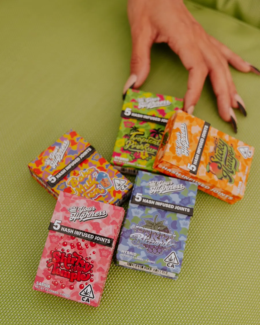 Hands reaching for Your Highness 5-pack hash infused pre-rolls